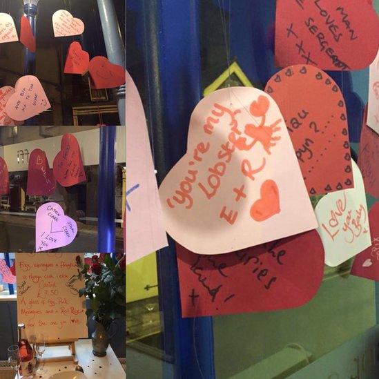 Heart cards with messages of love placed in the window at Gwin Dylanwad Wine, Dolgellau