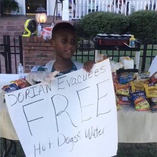 Jermaine Bell selling hot dogs and other supplies at a make shift stall