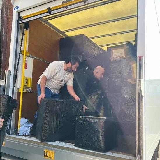 Men pack aid boxes