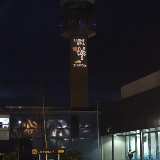 Air traffic control tower displaying hospice Christmas appeal message