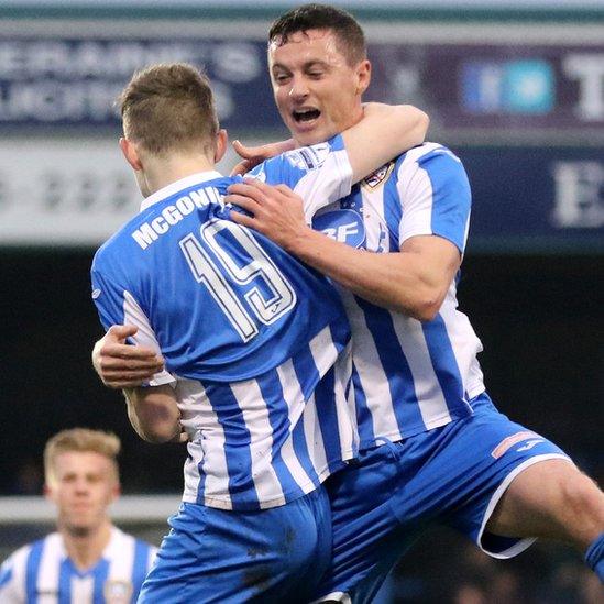 Goal scorer Jamie McGonigle celebrates with team-mate Ruairi Harkin after scoring in Coleraine's 2-1 win over Ballymena United