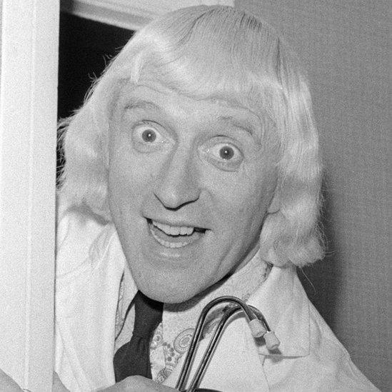 Jimmy Savile carrying a stethoscope