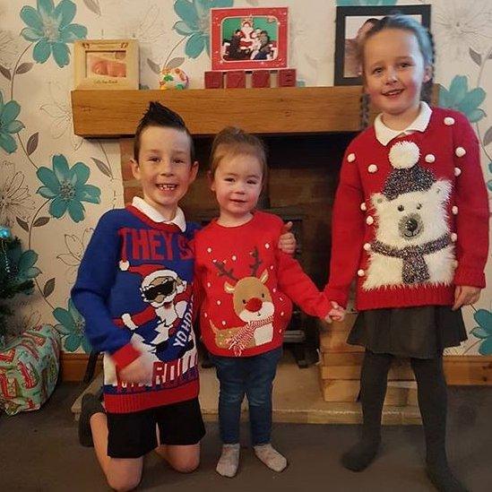 Children wearing Christmas jumpers