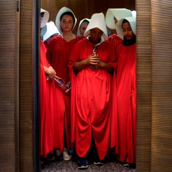 Protesters dressed as characters from The Handmaid's Tale