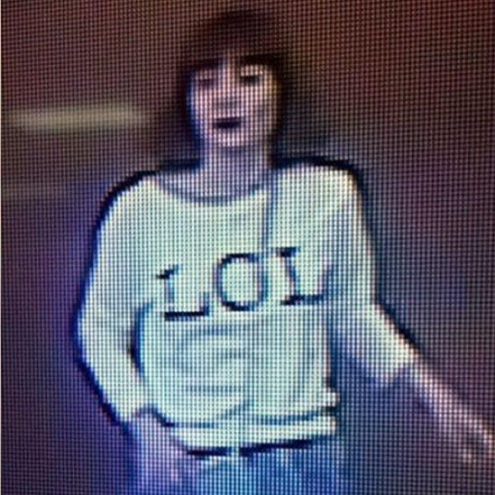 Grainy image shows a woman with brown hair wearing a T-shirt with the letters "LOL" emblazoned on it