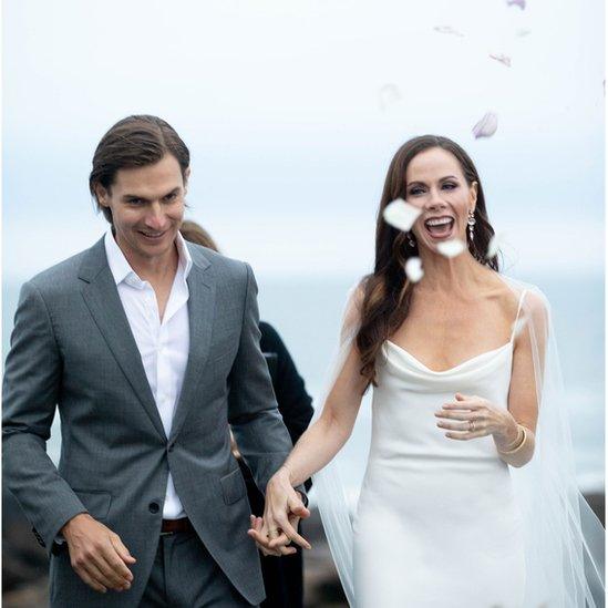 Bride and groom walk down the aisle