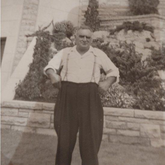 Old sepia photo of man in braces