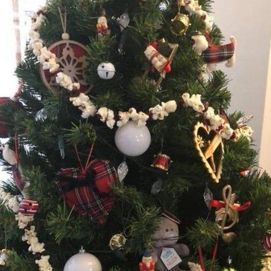 Garlands made of popcorn wrapped around Christmas tree