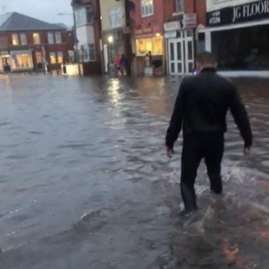 Person walking through flood water in Worksop