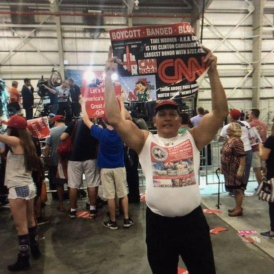 Twitter photo of Mr Sayoc holding an anti-CNN poster