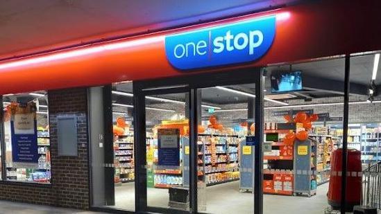 The entrance to the One Stop shop in Amesbury, at night