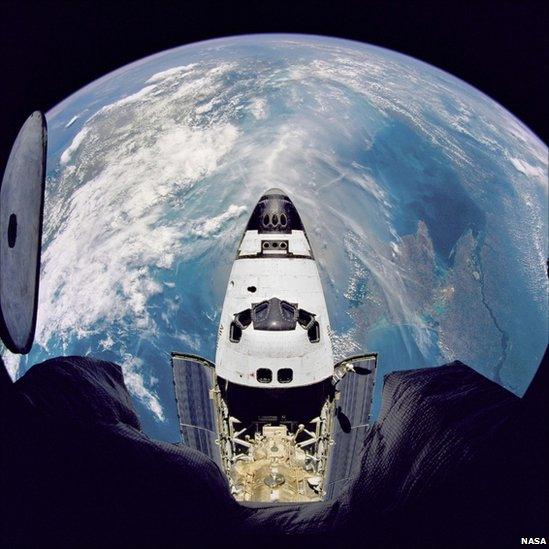 Fish-eye view of the Space Shuttle Atlantis in orbit as seen from the Russian Mir space station during the STS-71 mission