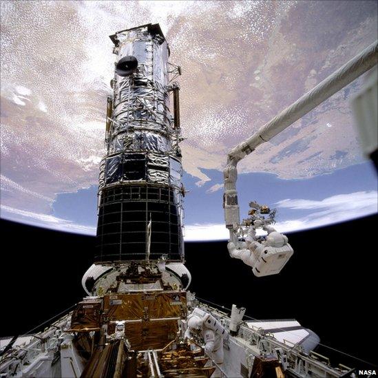 Astronaut F Story Musgrave prepares to be elevated to the top of the Hubble Space Telescope, 1993