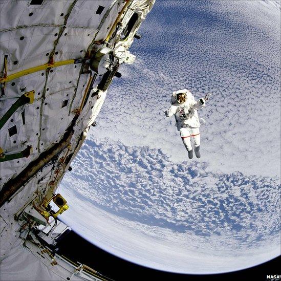 Astronaut Mark Lee tests the new Simplified Aid for EVA Rescue system aboard the Space Shuttle Discovery