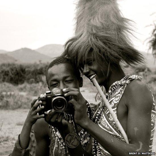 Men look at photos on a camera