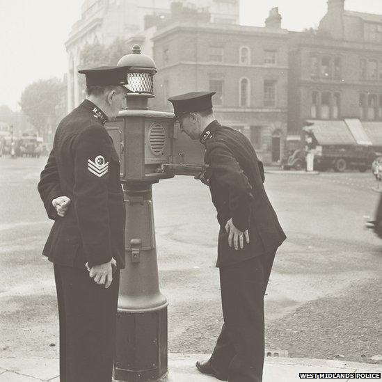 Two officers with a "police pillar" in September 1950