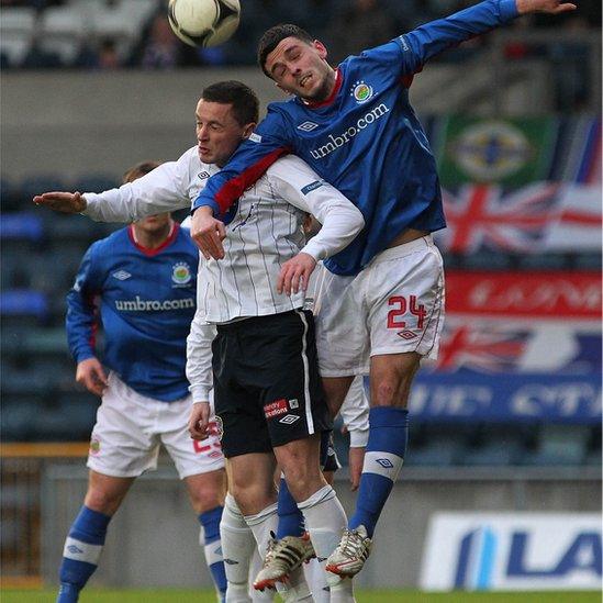 Ruairi Harkin of Coleraine and Linfield's Brian McCaul go up for a high ball during the Irish Premiership match at Windsor Park