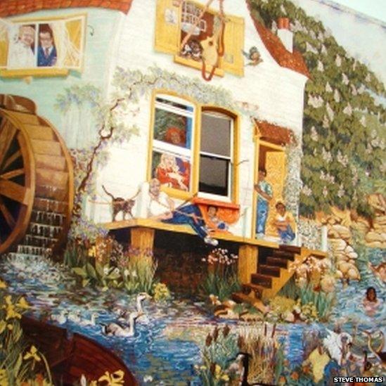 Huge mural covering the entire side of a house, of a watermill and mill pond with people swimming in it. Picture: Steve Thomas