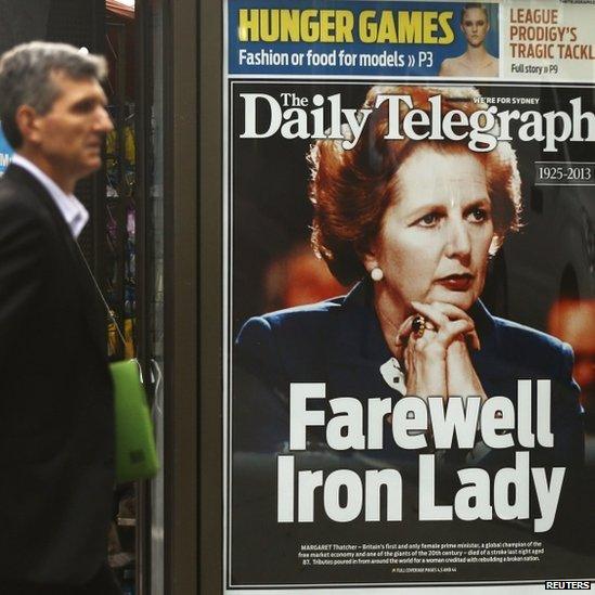 A man walks in front of a news stand with the portrait of former British prime minister Margaret Thatcher in Sydney on 9 April.