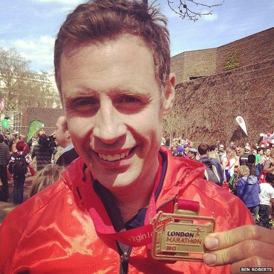 Runner shows off his medal. Photo Ben Roberts