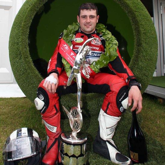 Michael Dunlop celebrates with the silverware after winning the Superbike race at the Isle of Man TT