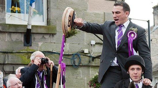 The nailing of a salted herring to a barley bannock is one of the most dramatic elements of the Langholm celebrations