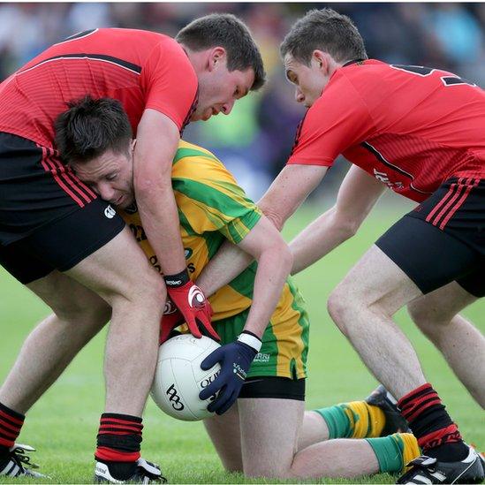 Donegal's Marty O'Reilly comes under pressure from Peter Turley and Declan Rooney of Down