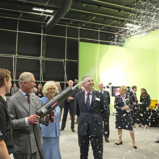 Prince Charles fires a snow gun on the Doctor Who set