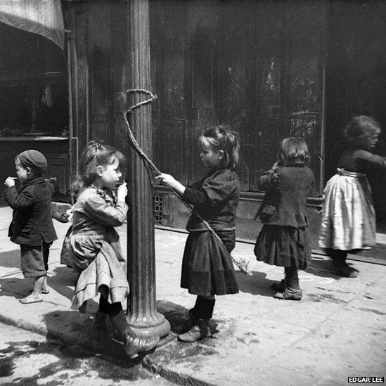 Children using street lamp for a swing, Edgar Lee, c 1892