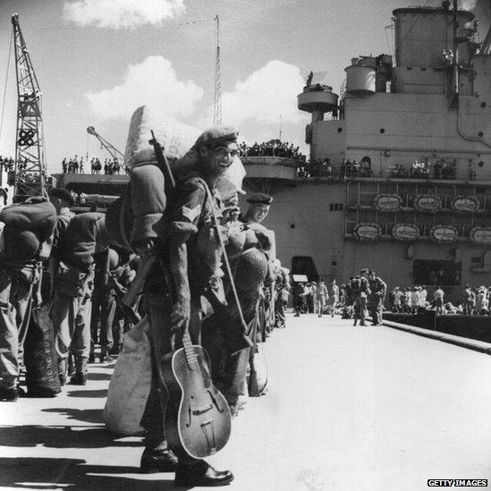 Men of the 1st Battalion of the Middlesex Regiment at Holts Wharf, Kowloon, Hong Kong wait to board HMS Unicorn. They are being sent to fight in the Korean War. August 1950.