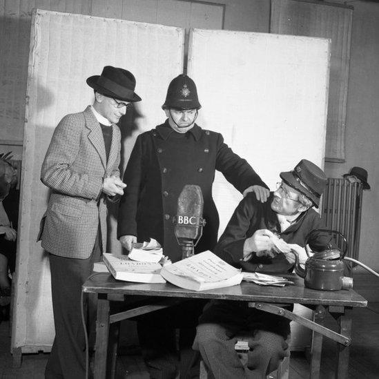 The postmaster (Jon Pertwee) is caught red-handed by the Vicar (David Jacobs) and PC Potts (Norman Shelley) - 1950