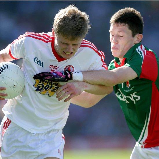 Padraig McGirr of Tyrone attempts to hold off Mayo's Sean Conlon during the Minor football final at Croke Park