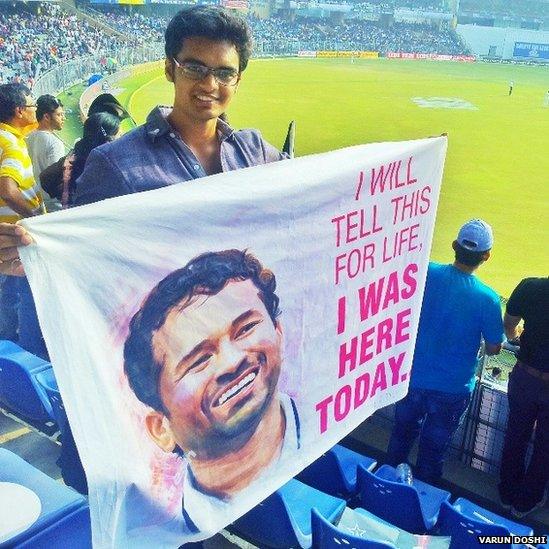 Varun Doshi holding a banner