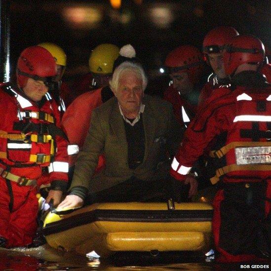 Man being rescued by boat