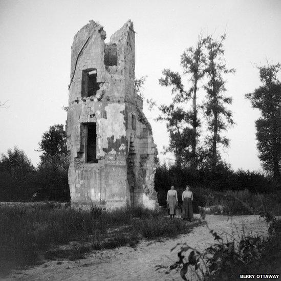 Destroyed building with two glum women