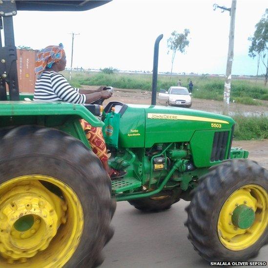 Woman driving tractor in of Lusaka in Zambia