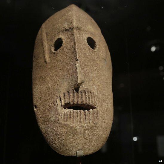 A 9,000 year-old mask is on display at the Israel Museum in Jerusalem on 10 March 2014.