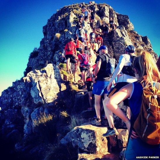 People climb mountain in Cape Town