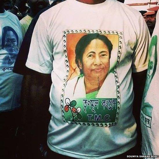 A Trinamool Congress Party supporter attends an election rally in Sonarpore wearing a Mamata Banerjee T-shirt.
