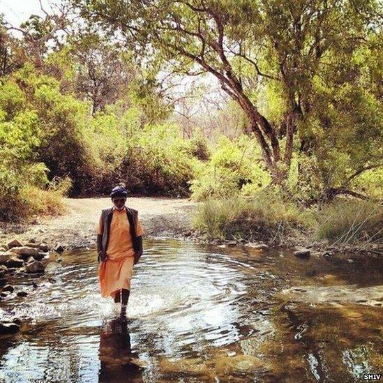 Darshandas – or Bapu, as he prefers to be called, crosses a stream on his way back to his ashram.