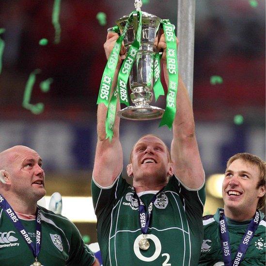 John Hayes and Stephen Ferris watch Paul O'Connell lift the Six Nations trophy after Ireland beat Wales in Cardiff to clinch the Grand Slam in March 2009