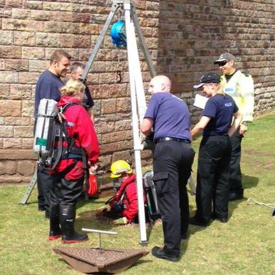 Police diver going down Cardiff Castle drain