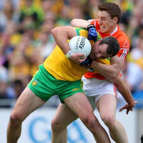 Armagh defender Charlie Vernon gets to grips with Donegal forward Michael Murphy