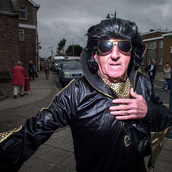 Elvis lookalike in black leather and gold