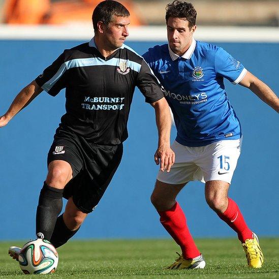 Ballymena striker Matthew Tipton in action against Sean Ward during Linfield's 3-2 win at Windsor Park