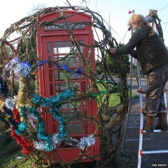 Jane Frost decorating a telephone box in Prickwillow