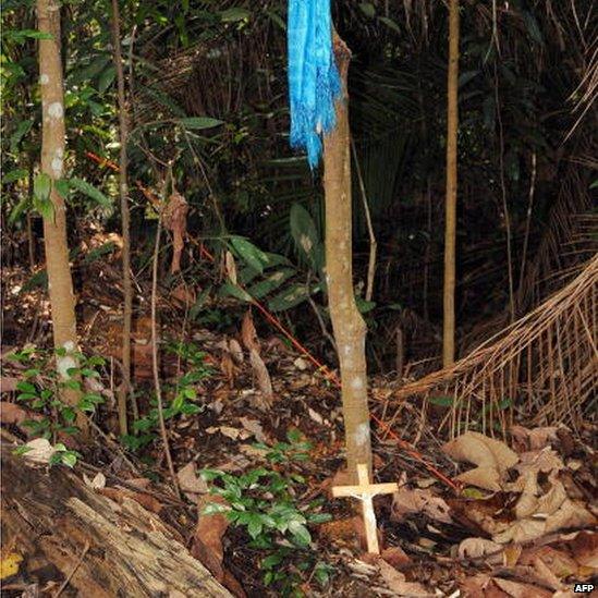 A crucifix lies at the crime scene in the forest where prosecutors allege Mongolian Altantuya Shaaribuu, 28, was murdered in Shah Alam, near Kuala Lumpur, 18 July 2007.