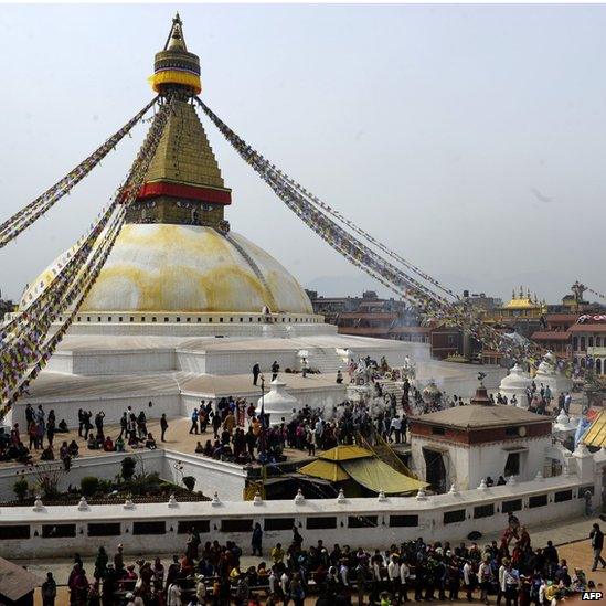 Tibetan community gather and throw flour at the Boudhanath Stupa during celebrations marking the third day of Losar Tibetan New Year in Kathmandu (March 4, 2014)