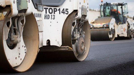 Steam rolling equipment on freshly laid tarmacadam