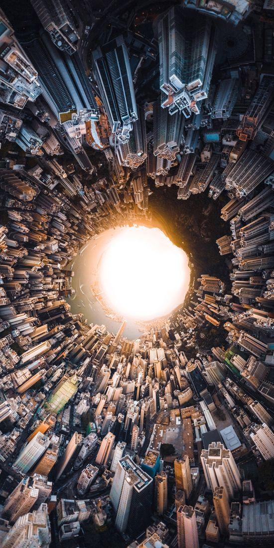 unusual effect used to take photo of city skyline, where the tall buildings appear to encircle the sun